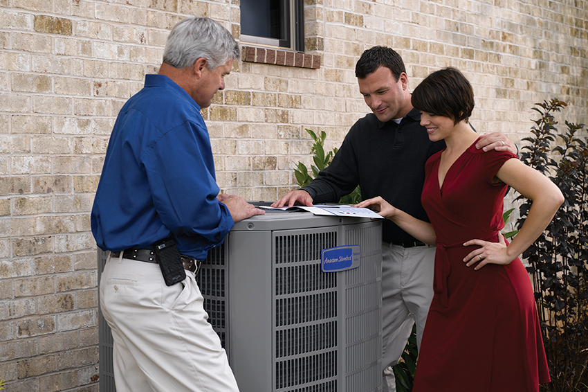 Couple Consulting With a Professional on AC Units